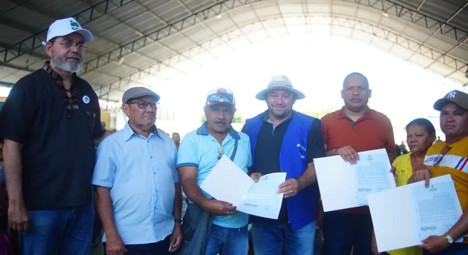 Sete pessoas, agricultores de Potengi, recebendo o titulo de propriedade de terra.