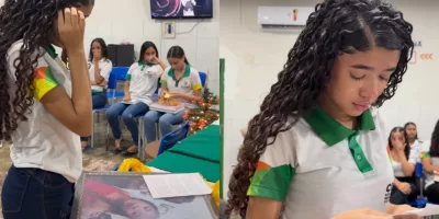 Emily aparece na sala emocionada com o presente que foi doado por um professor que adotou a ideia.