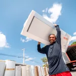 pessoa durante troca de geladeira em ação da enel ceará