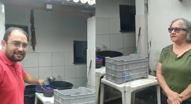 Dois servidores mostrando a cantina da escola municipal em Juazeiro do Norte com precariedade.