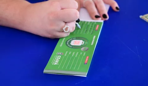 pessoa recebendo o vale gás. a imagem está focada nas mãos